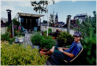 John Broere relaxes after five years of work creating a garden on his warehouse roof