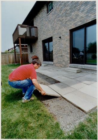 MacLean removes concrete patio slabs and sod to make way for an interlocking stone patio