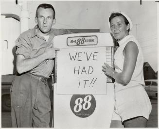Station operator Denny and wife hand up last price war sign