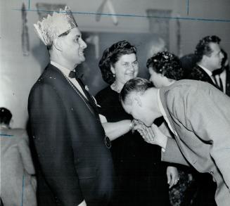 Perry Ryan kisses queen's hand as Rezso Dudas looks on