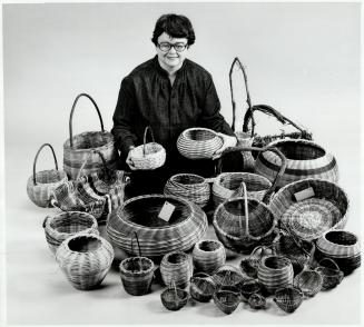 Melinda Mayhall surrounded by baskets she makes