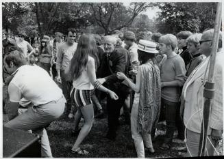 The love-in gave dignified Robert Gilgour chance to dance with pretty hippies on lawn at Queen's Park, when his Yorkville friends complained about the arrests at burn-in,