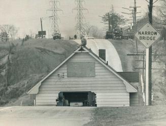 Adventurous Boy perches on the roof of a six-room house blocking richview road in Etobicoke, Bungalow owned by Mr