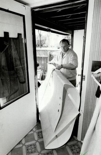 Flexible unit: Left, Bill Meyer demonstrates the flexibility of the unit his company manufactures, which allows it to be carried easily through any standard doorway