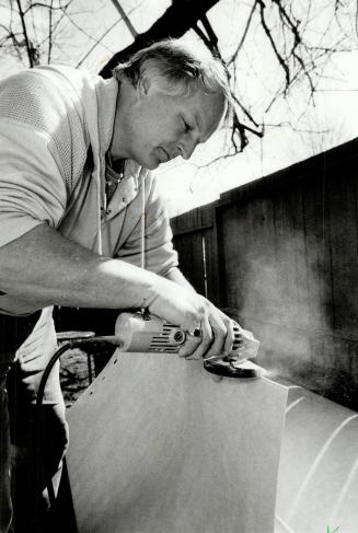 Helpful tool: Below, Bill Meyer demonstrates a disc-type sander, handy for making slight adjustments to the edges of the fibreglass unit