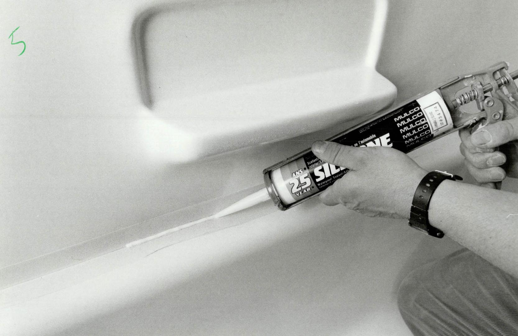 Apply caulking: Left, once insert is installed, silicone caulking is applied around bathtub and ceiling, masking tape placed on the edges of the tub and ceiling make clean-up simple