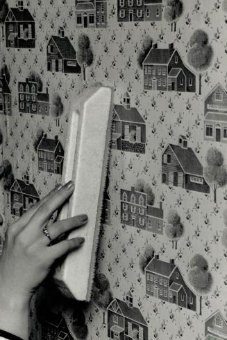 Easy steps: Nancy Douglas of Color Your World demonstrates some wallpapering steps, left to right: Read instructions, roll aper inside out, use the proper applicator to smooth out the paper