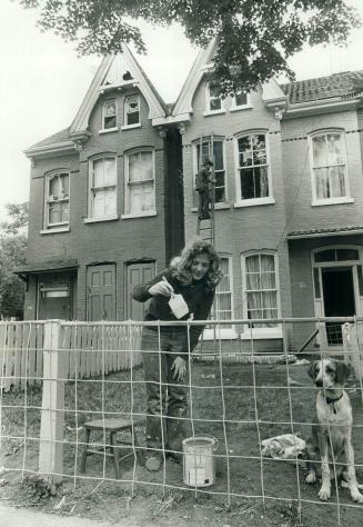 Mrs. Roberta Sankey and her husband paint their home on Bleeker St.