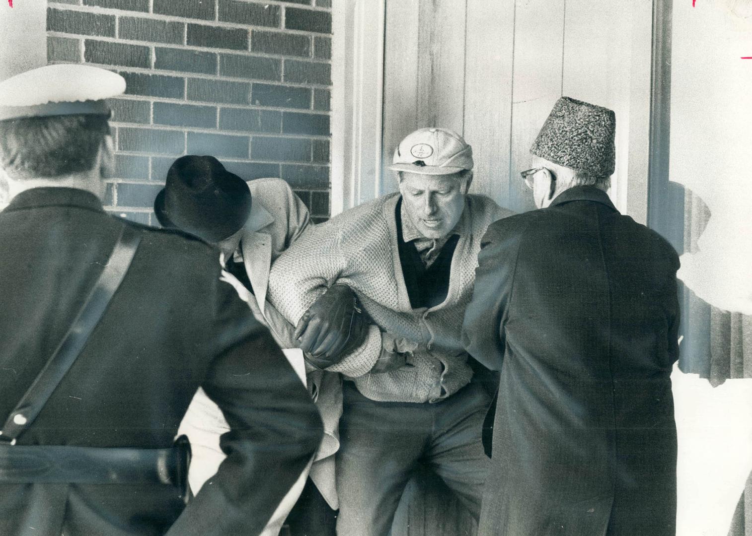 Dragged from his doorway after he tried to block sheriff's officers from evicting his family from their $75,000 luxury home near Buttonville yesterday(...)