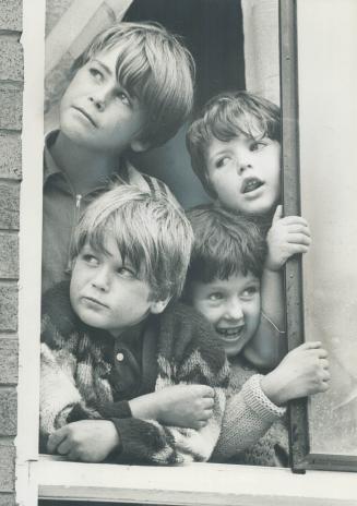 Waiting at the window for a worker from the Children's Aid to pick them up are these four children of Mrs
