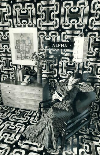 Johanna Renay relaxes in a room which has geometric carpet used on the floor and walls
