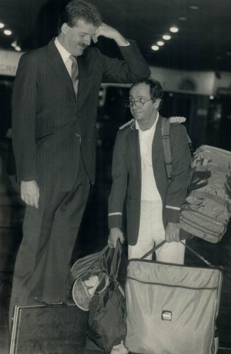 Hey, shortie! Lorry Cursio, a 5-foot, 6-inch bellman at the Cara Inn on Airport Rd
