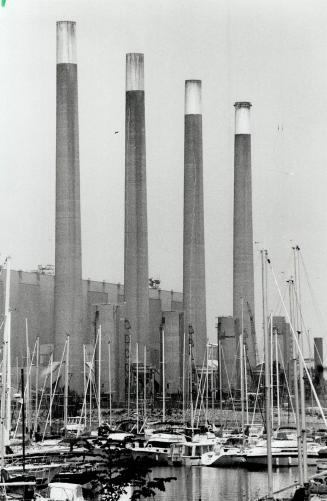 Four Sentinels: Boats nestle along the Port Credit waterfront against a backdrop of smokestacks at Mississauga's Lakeview Thermal Generating Station