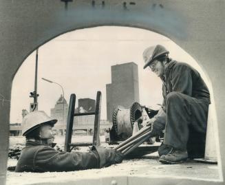 Now, in-sert plug 'A' in socket 'B', These men in the street are Toronto Hydro workers Sid Byatt, left, and Rob McEldon at work in a manhole at the fo(...)