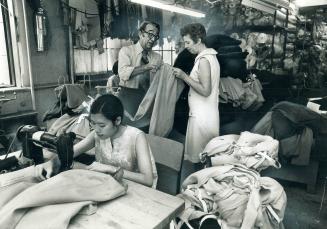 The finer points of a manufactured garment are explained to Etobicoke teacher, Eve James (right), by Morris Watkins, president of Miss Sun Valley comp(...)