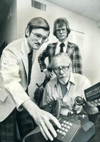 A device that enables deaf mutes to communicate by telephone is shown by its inventors (from left)
