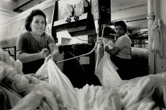 Endless Load, More than 200 employees in tow shifts handle tons of laundry that pass through the Brighton Laundry Co