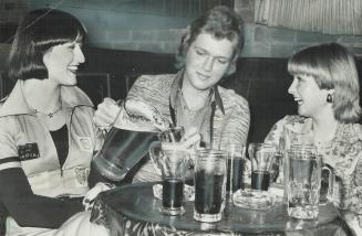 In a tavern on Yonge St. (from left) Diane Bruce, Tom Mankin and Debbie Chivers are over 18, the legal drinking age now, but in some cases beer is ser(...)