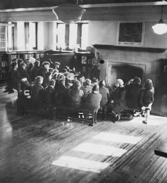 Image shows a group of children gathered inside the library.