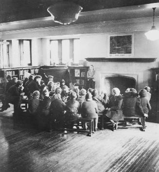 Image shows a group of people gathered inside the library.
