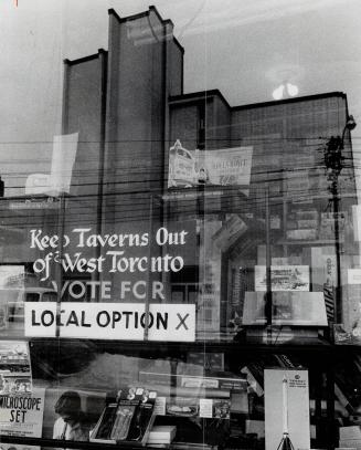 Dry sign in window opposite new hotel
