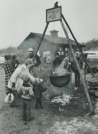The Cauldron Bubbles ? Sweetly, Spectators crowd around a big iron cauldron, hung from a tripod over an open fire, as Campbellville resident R. S. Cur(...)