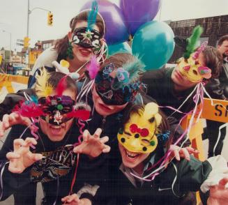 Carnival on the Danforth, Showing masks they made at Mardi Gras on the Danforth yesterday are, from left, Edward Goodwin, 12, Beth Goodwin, 15, Amy Go(...)