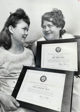 Mother And Daughter, Mrs. Melba Frail, and 13-year-old Sharon Frail hold police citations they received yesterday for aiding police in two separate in(...)