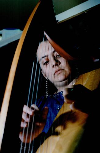 Music Lover: Menya Wolfe plays her harp
