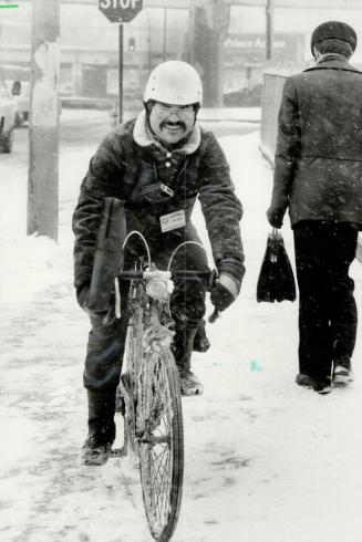 Snow? What snow? Bicycle parcel courier George Metropoulos, 19, takes his company's slogan seriously ? In rain, wind or snow, we go ? because that's w(...)