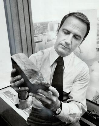 Prospector John Sadowski handles a chunk of gold-bearing rock