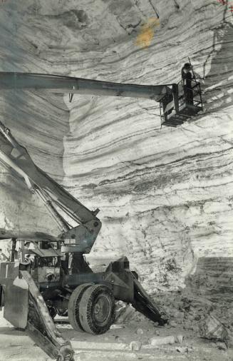 Dwarfed By the salt tunnel in which he works, a miner in a cherry-picker hoist knocks loose pieces of salt from the walls. One crew spends all its tim(...)