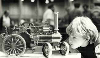 So that's what makes it run!, Five-year-old Christopher Cameron examines a scaled-down replica of a coal-fired tractor at the 11th annual Toronto Mode(...)