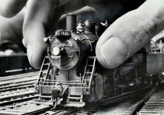Looks like King Kong putting his evil hands on the local express, but it's just a Scarborough Model Railroader