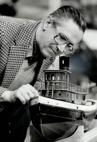 Norm Perkins checks out his steam-powered, radio-controlled model of the Toronto Island ferry Ned Hanlan