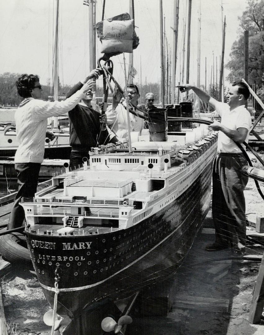 At left RCYC member Ken Greig in SCUBA gear goes beneath water to attach cables around sunken ship
