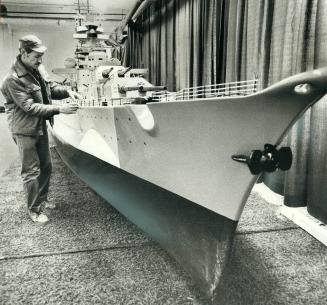 The Bismarck sails into sportsmen's show, German navy veteran Paul Gresser of Sharon checks over the 41 1/2 foot model of the German battleship Bismar(...)