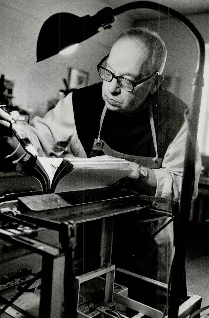 Work and prayer: Father Hilaire binds and repairs books