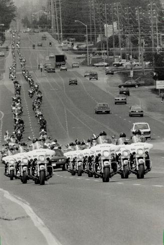 Motorcyclists ride for sight, The OPP's Golden Helmets lead a 13-kilometre (8-mile) parade of 4,000 motorcycles eastward on Highway 2 yesterday in the(...)
