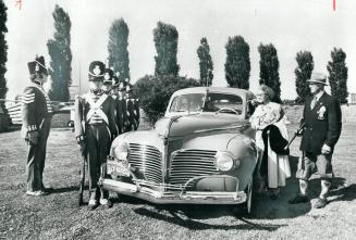 Red Coated Guards of Fort York stand at attention for this 1941 Luxury Liner Dodge D19, owned by Lillian and John Samson, right, who are in costume fo(...)