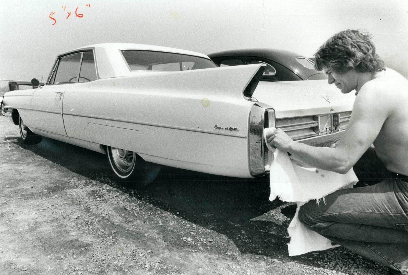 Frank Austin polishes 1963 Cadillac coupe
