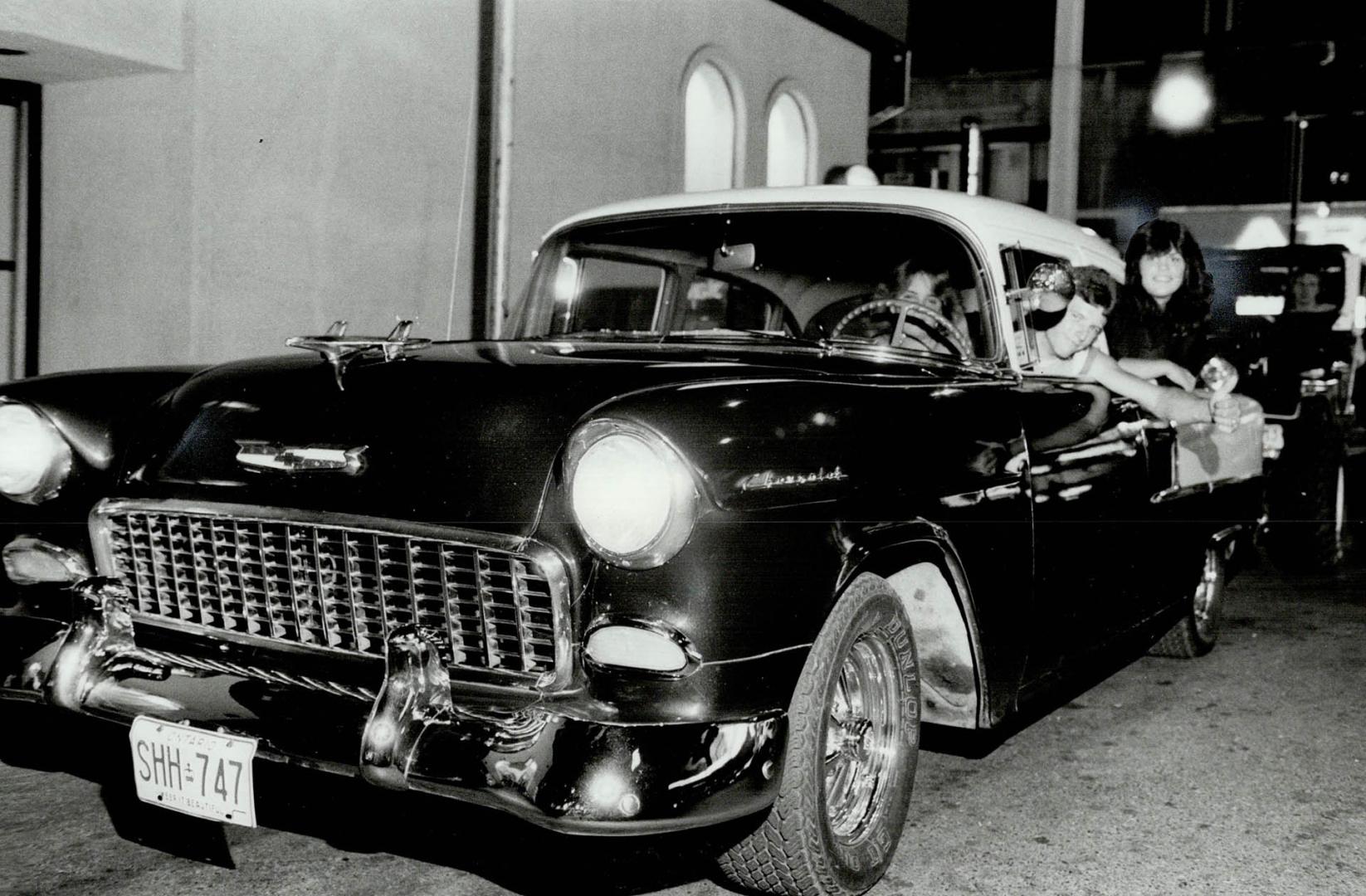 Souped-up Chev Steve Parkinson's '55 Chev has a 180 horsepower engine that obviously impresses the girls as they join him for another cruise along Yonge St