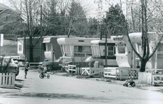 Neat Row of mobile homes is arranged along a street in a mobile home park at Long Branch