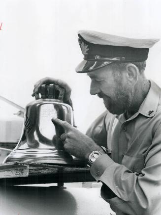 On HMCS Haida, the retired Canadian destroyer, Lieut, Frank Stockwell points to names of five babies engraved on bell