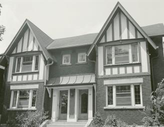 Image shows a two storey semi-detached residential house.