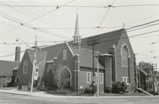 Image shows a street corner view of the St. Michael and All Angels Church.
