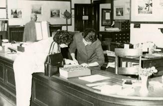 Mrs Leticia Maloles, Colombo Plan trainee from the Philippines, helping a borrower at Beaches Library (autumn, 1960)
