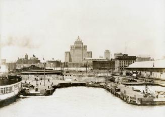 Image shows ferry docks with some buildings in the background.