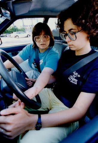 Instructor Monica Nelm offers some driving tips to student Mary Marrone