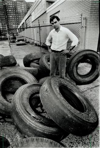 Trashy trick: Joe Kyriakakis arrived at his Scarborough firm yesterday morning to find a pile of 21 old tires dumped in the driveway